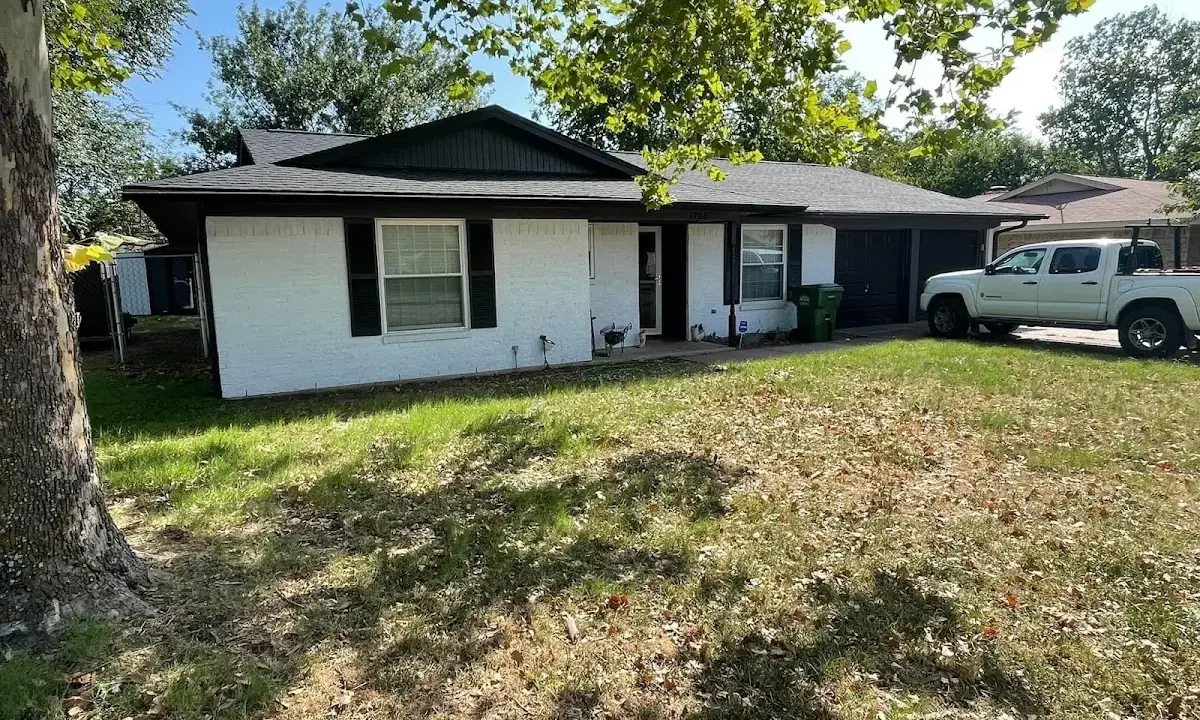 Professional roofing crew working on a residential roof in Ashwaubenon